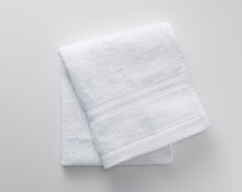 A Towel Placed On A White Background. View From Above