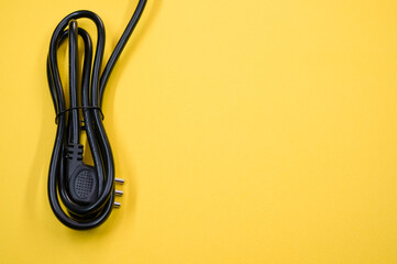 Poster - Black power cable on a yellow background