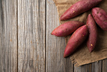 Sweet Potatoes On An Old Wooden Background