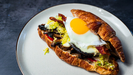 Wall Mural - Portobello Croissant Breakfast Sandwich with sunny up egg