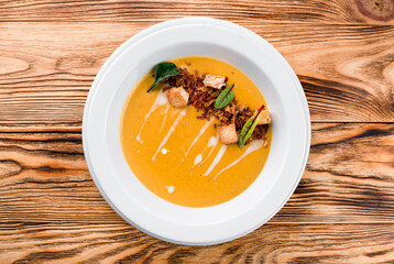 Sticker - Pumpkin soup on wooden background