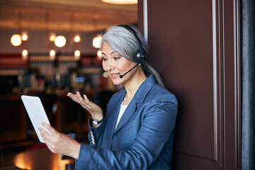 Wall Mural - Charming woman in headphones using tablet computer