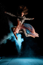 Beautiful Woman Effectively Jump High In The Air At Dark Time