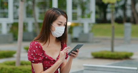 Canvas Print - Woman wear face mask and use of cellphone at outdoor