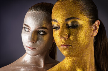 beautiful portraits two women in gold and silver powder