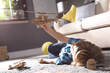 © New Africa - Little boy playing with cardboard helicopter on floor at home. Creative hobby