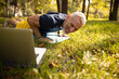 © Viacheslav Yakobchuk - Cheerful male with laptop exercising on grass