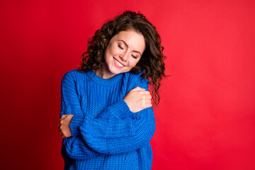 Sticker - Photo of cute pretty dreamy lady curly hairstyle beaming white smile cuddle herself eyes closed fantasize wear blue knitted sweater pullover isolated red color background