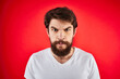 © SHOTPRIME STUDIO - man in t-shirt gesturing with his hands dissatisfaction studio red uniform