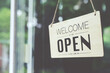 © methaphum - Welcome open sign on shop door. Text on cafe front or restaurant hang on door at entrance. vintage tone style.