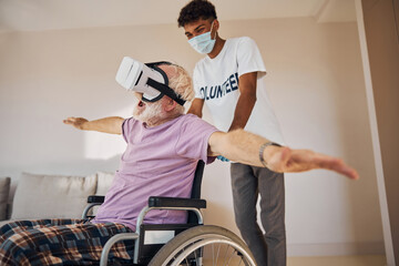 Wall Mural - Pleased senior Caucasian man enjoying virtual reality