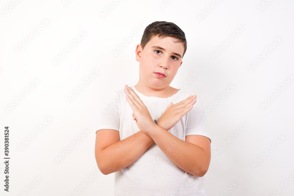 Caucasian young boy standing against white background Has rejection ...