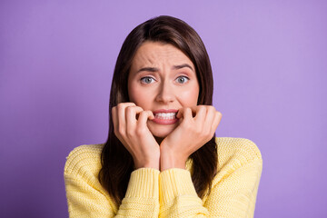 Sticker - Photo portrait of nervous troubled brunette girl biting fingers on both hands worrying wearing yello sweater isolated on vivid color violet background