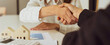© crizzystudio - Real estate agents shakehands to congratulate clients on accepting the offer to buy a home at a special price, home lease contract concept. And trading houses