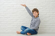 © yana_novak22 - Little boy measuring height near light wall