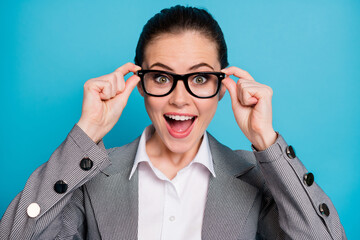 Poster - Close-up portrait of attractive smart clever cheerful lady touching specs isolated over vibrant blue color background