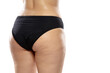 © master1305 - Back view. Overweight woman with fat cellulite legs and buttocks, obesity female body in black underwear isolated on white background. Orange peel skin, liposuction, healthcare and beauty treatment.