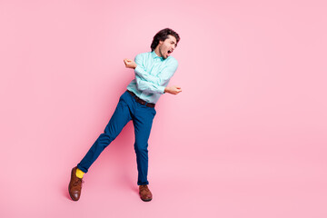 Wall Mural - Full length photo portrait of guy dancing screaming isolated on pastel pink colored background with blank space