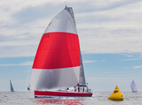 Fototapeta Łazienka - Racing yacht in ocean with red and white stripe sails 