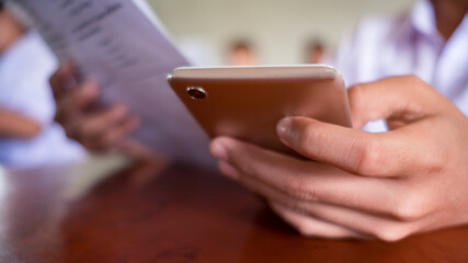 Exam by uniform  students doing educational test with using smartphone.16:9 style