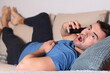 © ajr_images - Shocked man using phone in sofa