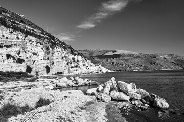 Wall Mural - Rocky cliff and boulders in Paliki Bay on the island of Kefalonia