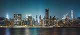 Fototapeta Nowy Jork - New York City Cityscape during Night Time with busy skyline and dense vibrant skyscrapers filling up the sky and lighting up the city