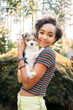 © Inti St. Clair - Portrait of happy, smiling teen girl with puppy