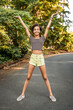 © Inti St. Clair - Happy, smiling mixed race teen girl outside with arms raised in the air