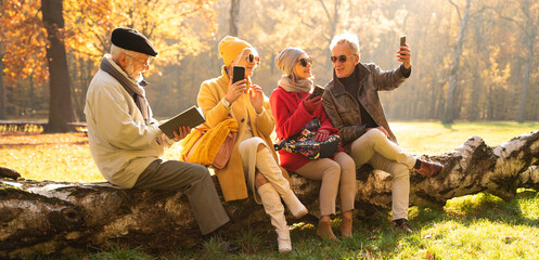 Wall Mural - Retired friends spending time together outdoor.