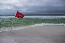 Red Warning Flag On The Beach