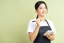 Asian Waitress Holding A Note In Hand
