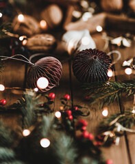 Paper ball garlands with Christmas lights on a wooden table