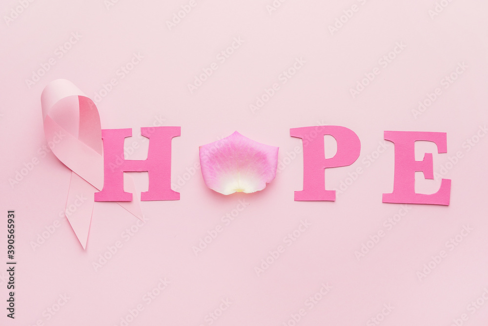 Pink ribbon and word HOPE on color background. Breast cancer awareness concept