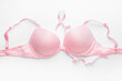 © Pixel-Shot - Pink ribbon and bra on white background. Breast cancer awareness concept