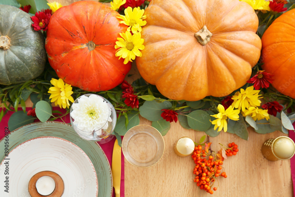 Beautiful table setting with pumpkins in dining room
