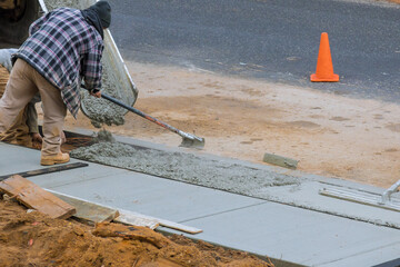 Canvas Print - Men working on a new concrete driveway at residential home