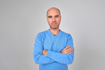 Casual handsome man smiling at camera, hands in pocket.