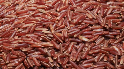 Wall Mural - A heap of brown rice. Close-up view, rotation, seamless loop.