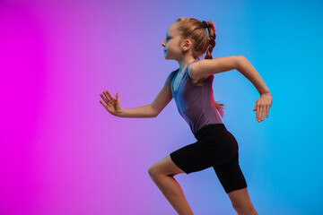 Profile. Teenage girl, professional runner, jogger in action, motion isolated on gradient pink-blue background in neon light. Concept of sport, movement, energy and dynamic, healthy lifestyle.