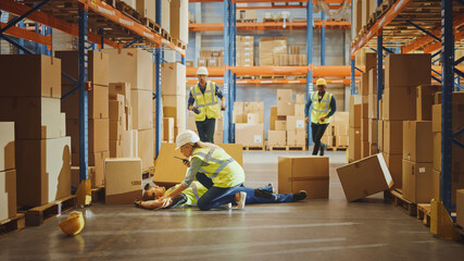 Wall Mural - warehouse worker has work related accident falls while trying to pick up cardboard box from the shel