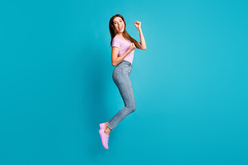 Sticker - Full length photo of attractive cheerful student lady wear casual purple t-shirt jeans jumping high isolated blue color background