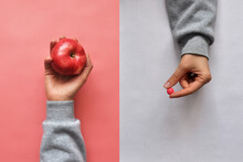 Food Additives And An Apple In People's Hands. Choosing Between Vitamins In Tablets And Vitamins In Fruits