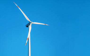 Wall Mural - single wind electricity power turbine against clear blue sky