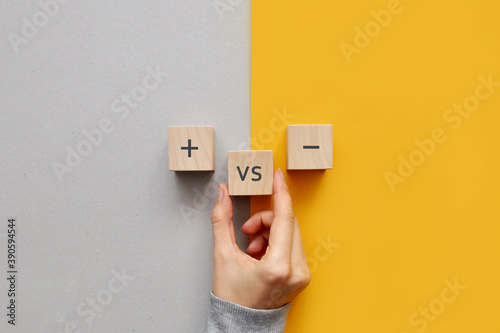 Wooden cubes with the image of pros versus cons. cons and pros in a person\'s life