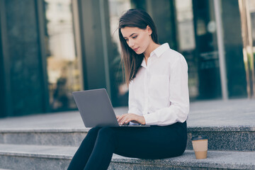 Poster - Photo of serious sweet young woman assistant wear white formal shirt typing modern device sitting stairs outdoors