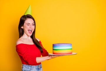 Sticker - Profile side view portrait of her she nice attractive flirty cheerful girl holding in hands presenting fresh cake winking having fun isolated bright vivid shine vibrant yellow color background