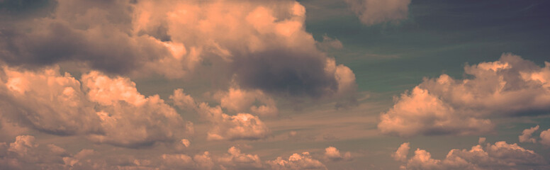 Wall Mural - toned dramatic sky background. blue gray sky with orange pink clouds. cloudscape. fantastic sunset.