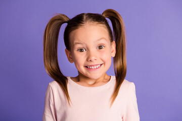 Photo of happy cheerful little girl wear sweatshirt excited smile isolated on violet purple color background