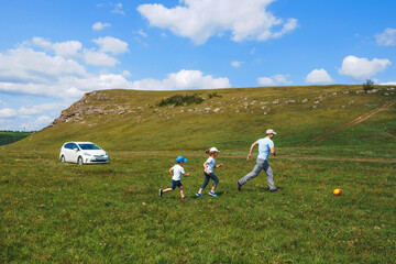 Wall Mural - father playing with children with ball